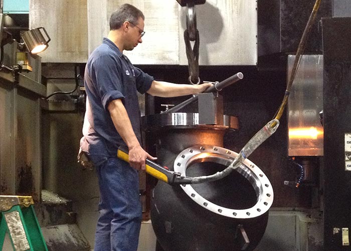 A Sadler employee works with a large machine