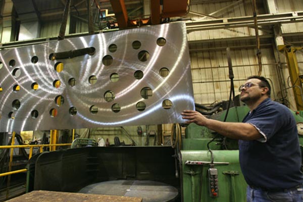 A man inspects some pipes